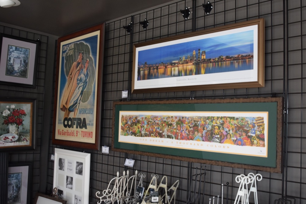 Framed pieces installed on a lobby wall by Bluegrass Frames