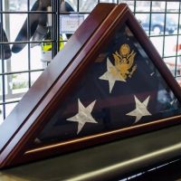 Military flag display case Folded military flag in a hardwood display case