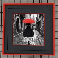 Red umbrella print in a custom frame Black and white street print with a red umbrella, double matted in a red frame