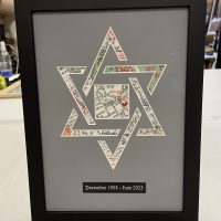Star of David map art Star of David formed from map prints, framed with a grey mat and engraved plate